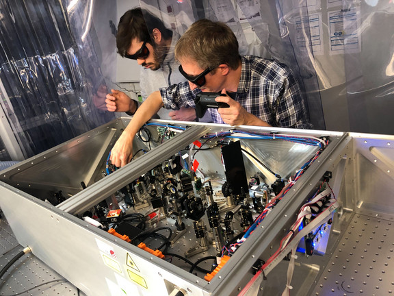 Cristian Manzoni (right) and Michele Capra (left) working together on one of our laser setups.