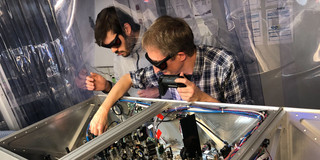 Cristian Manzoni (right) and Michele Capra (left) working together on one of our laser setups.